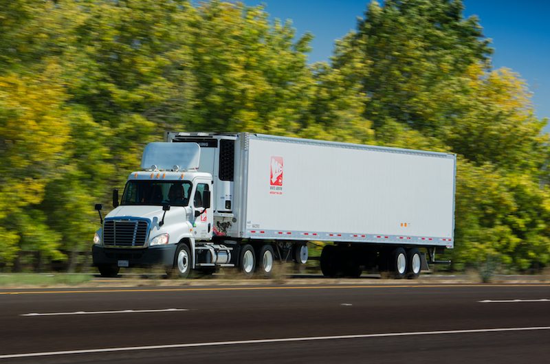 A White Arrow tractor-trailer on the road